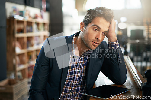 Image of Stress, upset and businessman with a tablet in the office while working on a corporate project. Technology, migraine and professional male employee with a digital mobile for a report in the workplace