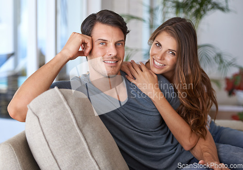 Image of Love, portrait of a happy couple bonding and on sofa in living room in their house. Marriage or relationship, romantic or intimate and relax or quality time together at home on couch in lounge