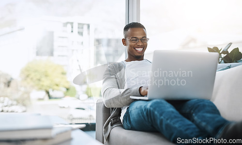 Image of Man, laptop and working on home sofa or remote work, elearning or distance job and online study, freelance or email communication. African male, happy on computer and apartment or living room