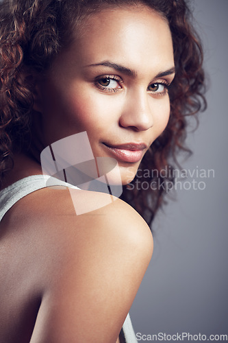 Image of Smile, attractive and portrait of model woman isolated on a dark background in studio. Stylish, confident and a young lady with happiness, curly hair and looking beautiful on a backdrop for modeling