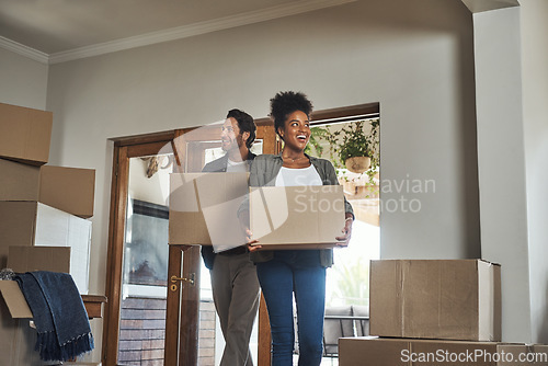 Image of Happy couple, real estate and boxes in new home for renovation, investment or relocation together. Interracial man and woman real estate owner carrying box in house, move or mortgage for property