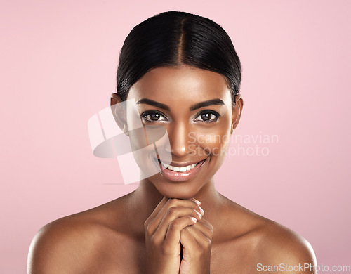 Image of Face portrait, skincare and smile of woman in studio isolated on a pink background. Natural beauty, aesthetic and Indian female model with makeup, cosmetics and spa facial treatment for healthy skin.