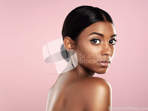 Image of Serious face, skincare and woman in studio isolated on a pink background mockup space. Natural beauty, portrait and Indian female model with makeup, cosmetics or spa facial treatment for healthy skin