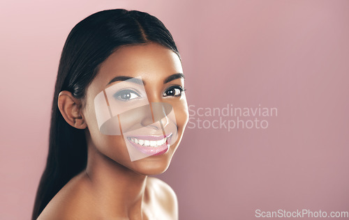 Image of Face portrait, skincare and smile of woman in studio isolated on a pink background mockup. Natural, beauty and Indian female model with makeup, cosmetics and spa facial treatment for healthy skin.