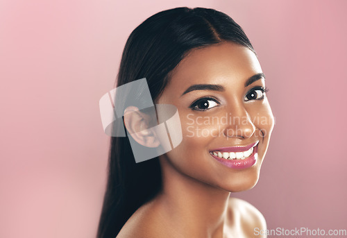 Image of Face portrait, skincare and happy woman in studio isolated on a pink background mockup space. Natural, beauty and Indian female model with makeup, cosmetics and spa facial treatment for healthy skin.