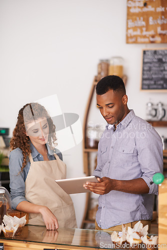 Image of Tablet, coffee shop and barista teamwork of people in discussion and training in cafe. Waiters, black man and happy woman in restaurant with technology for inventory, stock check or managing sales.