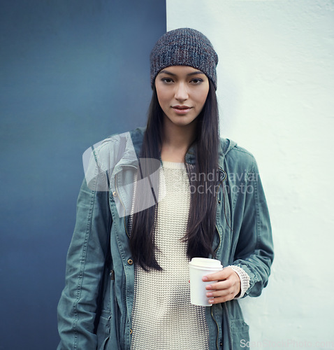 Image of Portrait of a woman with a cup of coffee by a wall with a casual, trendy and stylish outfit. Beautiful, gen z and young female person with takeaway warm beverage and cool fashion or style in the city