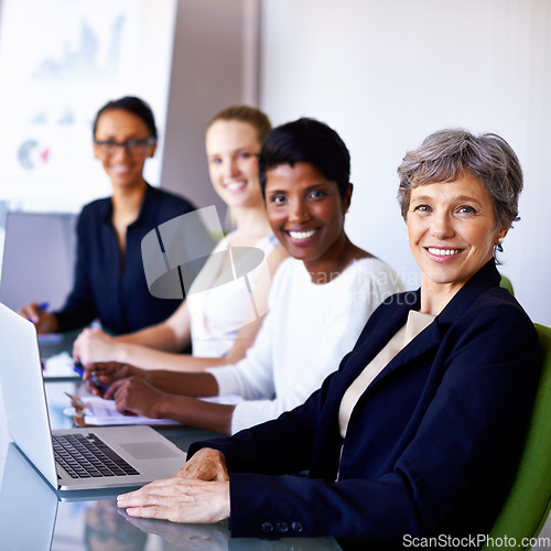 Image of Portrait, corporate team and women in a meeting at office with a laptop for workshop or planning. Face of senior woman or leader happy about teamwork, group diversity and collaboration at table