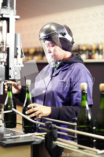 Image of Alcohol, bottle wine and woman working in a distillery or industrial factory. Equipment, glass bottles and female worker with ppe work on red champagne beverage production machine in warehouse