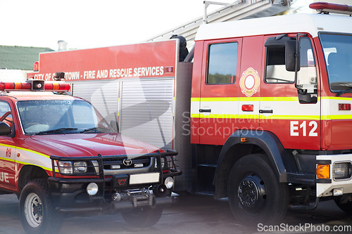 Image of Fire engine, truck and rescue services at station ready for firefighting, emergency and transportation. Firefighter vehicles parked outside for safety, transport and equipment for brigade protection