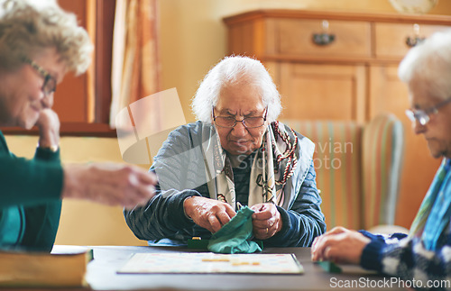 Image of Senior women, board game and nursing home friendship or old people, thinking and play games together in retirement. Elderly group, entertainment or hobby, retired friends and assisted living activity