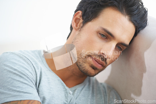 Image of Face, male model and depression or sad, mindful and head on wall while isolated on studio white background. Mental health, stress and tired man thinking of problem or suffering in silence of failure