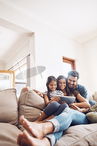 Image of Love, smile and family on a couch, tablet and happiness at home, relax and connection for social media. Parents, happy mother and father on a sofa, technology and online reading with a female child