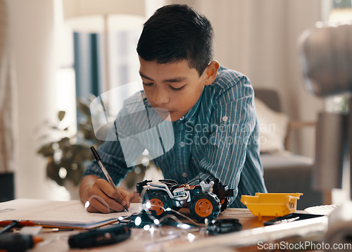 Image of Learning, writing in notebook and kid with robotics homework, homeschool and science for tech project. Taking notes, car robot and boy child with knowledge, education and studying in house alone.