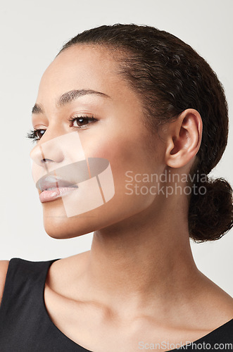 Image of Black woman, profile and natural beauty with confidence and cosmetics in a studio. Isolated, white background and young face of a African female person and model relax with makeup and confidence