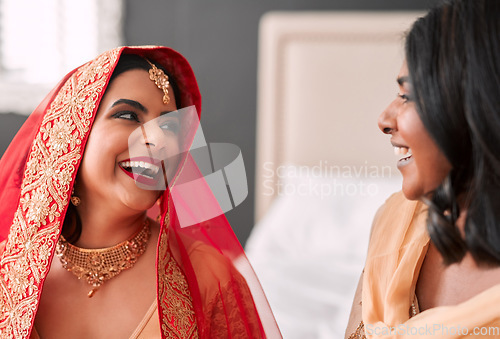 Image of Laughing, bride and bridesmaid getting ready for a wedding, happy and helping in a room. Support, love and a young woman in traditional Indian clothes for marriage ceremony with a friend or sister