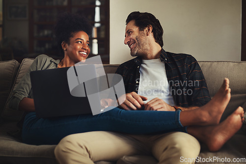 Image of Laptop, relax and an interracial couple streaming a movie using an online subscription service for entertainment. Computer, watching or internet with a man and woman bonding together over a video