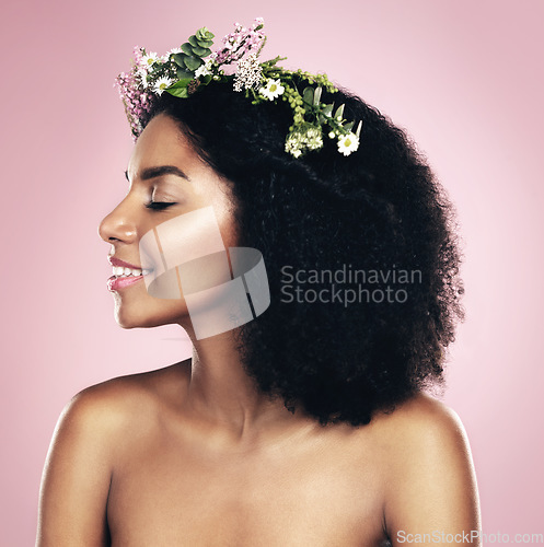 Image of Happy woman, face and flower crown for beauty in studio, pink background and natural skincare. Smile, african model and plants for floral wreath, spring cosmetics and dermatology of afro hair care