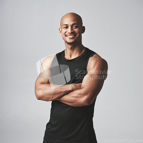 Image of Fitness portrait happy man and arms crossed isolated on studio background, healthy body or muscle workout. Smile on face of strong athlete, USA bodybuilder or African person, exercise or sports power