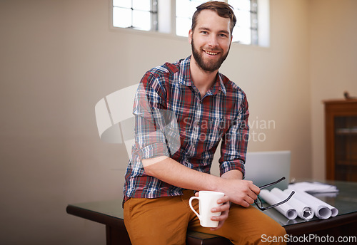 Image of Portrait, employee and man in his workshop, business and blueprints with ideas, skills and coffee cup. Face, male entrepreneur and builder in his office, documents and paperwork with startup success