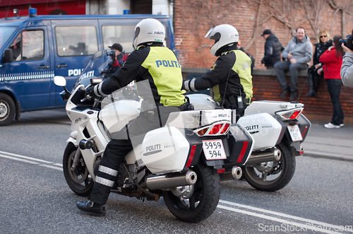 Image of Police, law enforcement and men on motorcycle in street with transport, public servant and security in the city. Safety, male people on patrol or escort for event with policeman on transportation