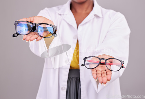 Image of Glasses in hands, choice and vision with optometrist, prescription lens and frame isolated on studio background. Person with eyewear, ophthalmology and health insurance, product to help with eyesight