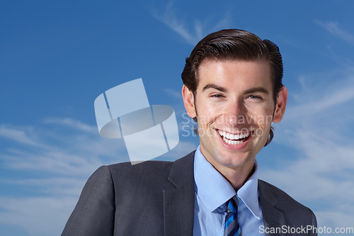 Image of Portrait, smile and happy man outdoors for business travel against a blue sky background. Face, empowered and businessman person excited while traveling, laughing and cheerful, confident and free