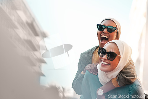Image of Muslim women, friends and piggyback in city with mockup space, travel and comic adventure together. Islamic woman, happiness and walking in metro cbd with funny game, sunglasses and bond on journey