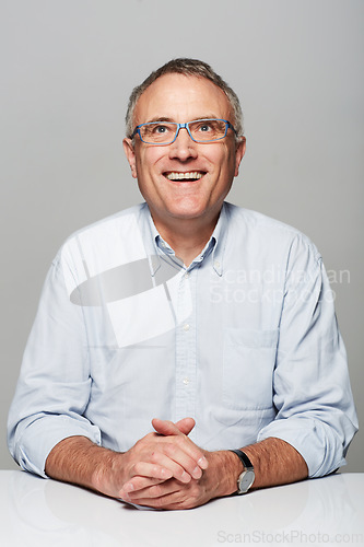 Image of Happy, smile and mature man in a studio with a good, confident and positive mindset with glasses. Happiness, spectacles and senior male person with excited face expression isolated by gray background