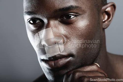 Image of Art, beauty and serious face of black man on dark background with skin care, and dermatology. Health, wellness and male skincare cosmetics and fit, healthy African model closeup on studio backdrop.