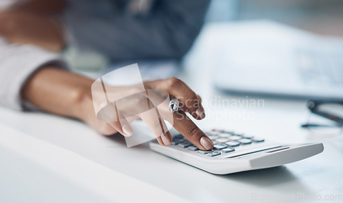 Image of Calculator, accounting and woman hand working on finance investment report in office. Professional, taxes and closeup of female financial advisor doing calculation for asset management in workplace.