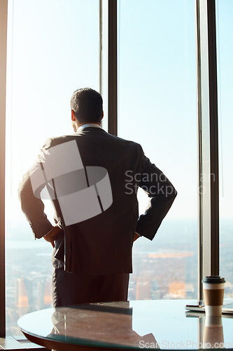 Image of Building window, business man and thinking of ideas, plan or vision with cityscape. Professional male executive with hands on hips for inspiration, dream and corporate development from behind