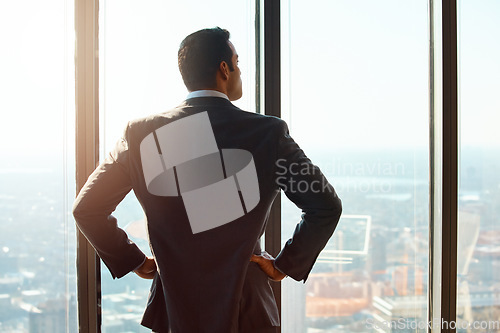 Image of Business man, building and window for thinking of ideas, future plan or vision by cityscape. Professional male executive with hands on hips for inspiration, dream or corporate development from behind