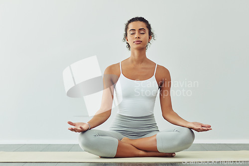 Image of Yoga, meditation and woman on mat for wellness, breathing exercise and healthy body in studio. Fitness, spiritual zen and female person meditating for calm, peace and relax for balance and wellbeing