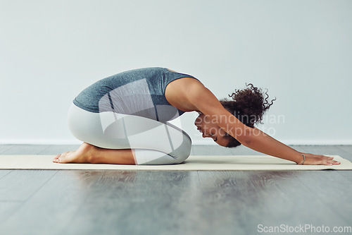 Image of Yoga, child pose and woman stretching on mat for wellness, workout and fitness in gym studio. Healthy body, meditation and female person doing pilates exercise for balance, flexibility and wellbeing