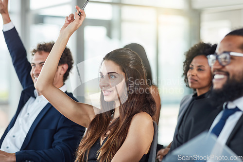 Image of Business woman, hands raised and questions at conference, seminar or meeting. Smile, audience and hand up for question, asking or answer, crowd vote and group training at workshop presentation event.