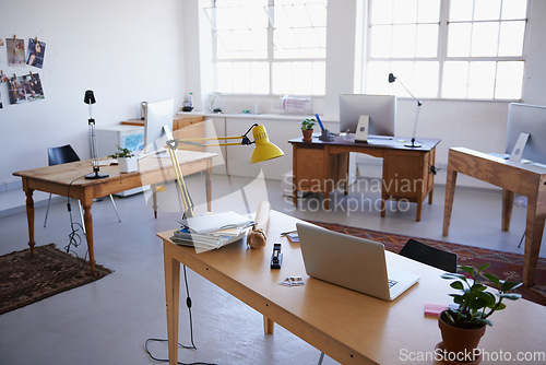 Image of Empty office, startup or laptop on desk in workplace, company or workspace room for business. Background, modern interior design or wooden table furniture with nobody or stationary in digital agency