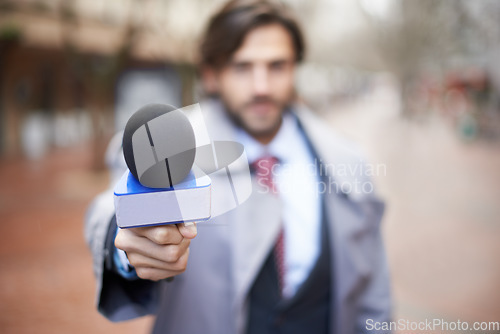 Image of Interview, man and hand with microphone for press, news broadcast or question in the city. Tv journalist, conversation and a male reporter with a mic for discussion, interviewing and work in media