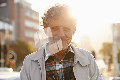 Image of Mature, portrait and man in the city with lens flare and happiness from retirement. Sunshine, urban street and old male person face with freedom and a happy smile outdoor on holiday in New York