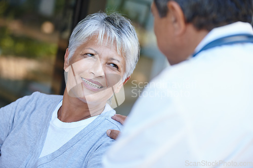 Image of Senior, smile and woman talking to her doctor, consultation or conversation. Consulting, medical professional and female person in discussion with healthcare physician for health, wellness or checkup