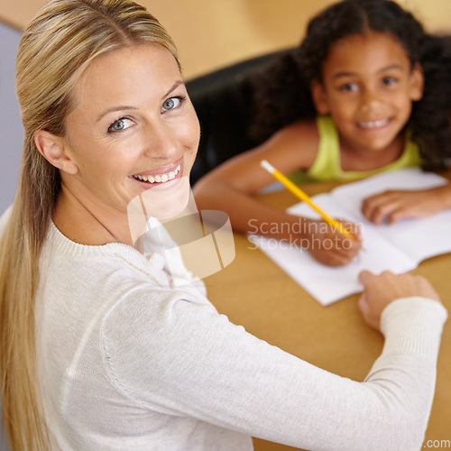 Image of Private tutor, portrait and child to learn in class at desk at school for an education with support. Woman, teaching and writing student with smile for learning or reading in the classroom for study.