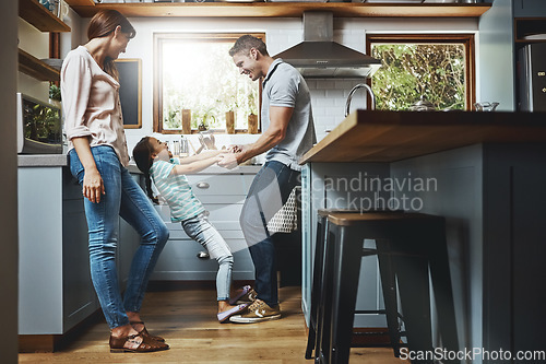 Image of Kitchen, family and dance together in home or bonding, child and father holdings hands, love and quality time in house. Girl, dad and mom with affection, fun and relax or dancing and laughing