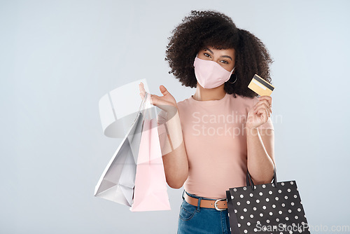 Image of Woman, face mask and shopping bags with credit card portrait for fashion, sale or discount deal. Female person or customer with a retail bag for promotion offer in studio space and white background