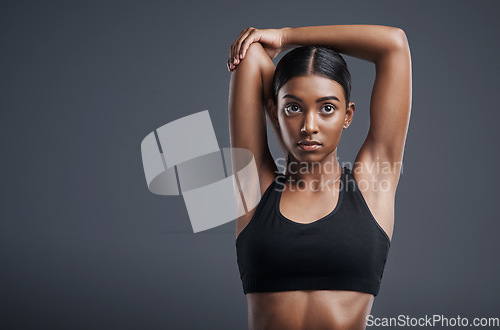 Image of Thinking, fitness and stretching with an athlete woman in studio on a gray background for health on mockup. Exercise, idea and warm up with an attractive young female model training her body