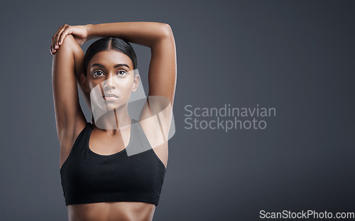 Image of Fitness, wellness and stretching with an athlete woman in studio on a gray background for mindset or health. Exercise, mission and warm up with an attractive young female model training on mockup