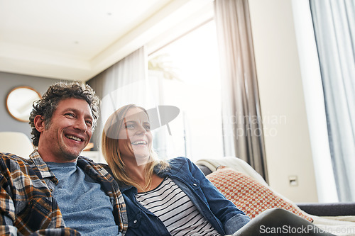 Image of Laughing couple, relax and watching tv in home for funny movie, comedy show and media connection in lounge. Mature man, happy woman and smile for television, video subscription and streaming platform