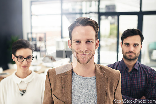 Image of Portrait, collaboration and leadership with a business man and his team standing in the office together. Management, leader and teamwork with a group of businesspeople looking confident about work