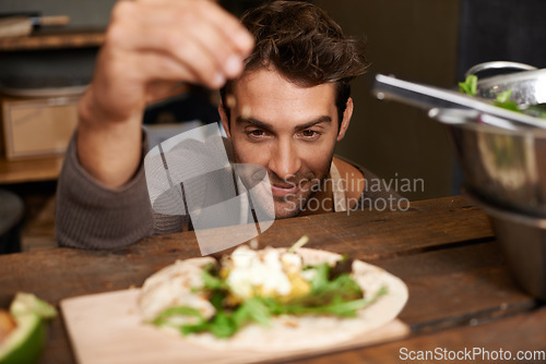 Image of Chef, man and seasoning food in kitchen for delicious meal, healthy diet and nutrition. Cooking, sprinkle spices and male cook preparing dish for fine dining in rustic restaurant or small business.