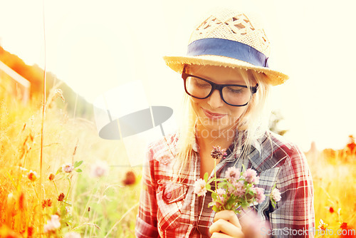 Image of Lens flare, countryside and woman with flowers in field for freedom, wellness and fresh air outdoors. Nature, summer and happy female person in natural meadow for relaxing, calm and peace in morning