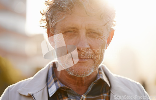 Image of Portrait, sunset and a senior man in the city during the day for travel or tourism during retirement. Face, wrinkles and lifestyle with a handsome male person standing outdoor in an urban town flare